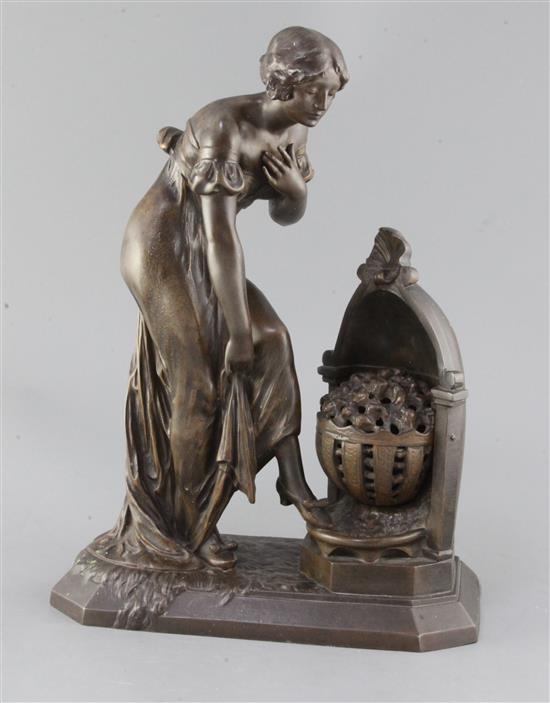 Julien Caussé (1869-1914). A bronze figure of an elegant lady warming her feet beside a brazier, height 15in.